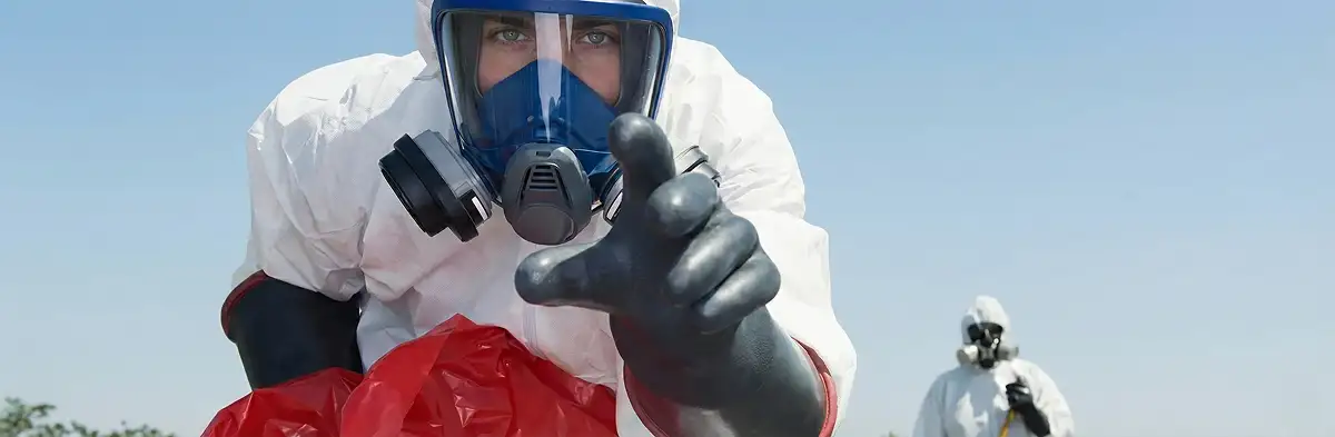 sewage clean up technician wearing protective gear handling biohazard materials in Madison, WI