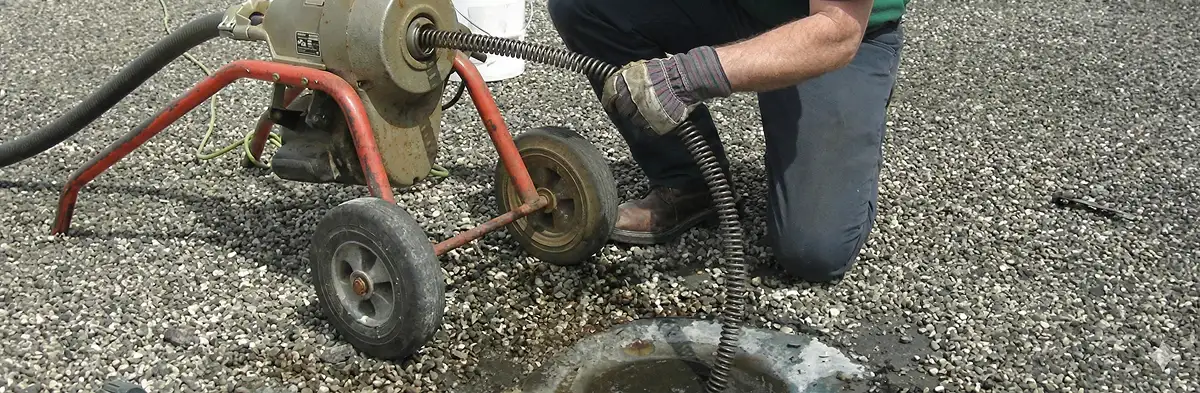 sewer rodding technician actively removing blockages from a sewer line in Madison, WI