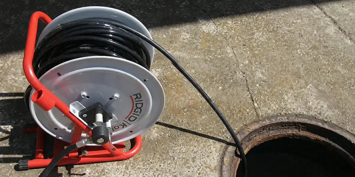 sewer rodding equipment prepared to clear clogged sewer lines in Madison, WI